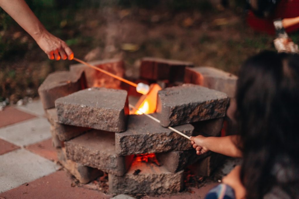 stacked stone fie pit - family roasting marshmallows